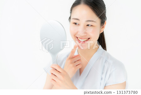 Woman looking in the mirror dental 131373780