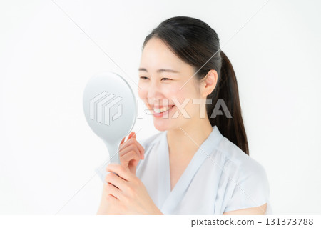 Woman looking in the mirror dental 131373788