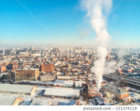Winter town. Frosty sunny day in the city. Snow on the streets and smoke from the boiler rises. Frost and sun, a wonderful day 131374119