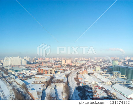 Winter town. Frosty sunny day in the city. Snow on the streets and smoke from the boiler rises. Frost and sun, a wonderful day 131374132