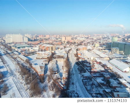 Winter town. Frosty sunny day in the city. Snow on the streets and smoke from the boiler rises. Frost and sun, a wonderful day 131374133