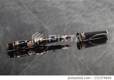 A fountain pen against a dark marble background. Rare writing instruments. 131374608