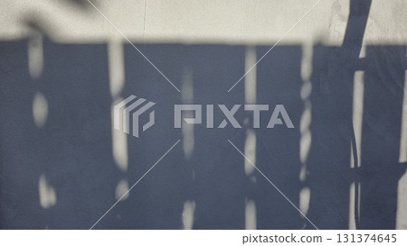 Old concrete wall, natural texture. Light background. Shadows from the fence. 131374645