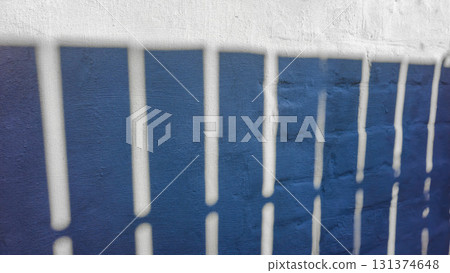 Old concrete wall, natural texture. Light background. Shadows from the fence. Old concrete wall, natural texture. Light background. Shadows from the fence. 131374648