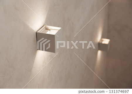Small wall lamps on the staircase in a private house Small wall lamps on the staircase in a private house 131374697