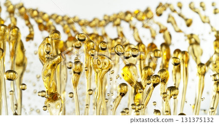 Freeze Motion of Abstract Oil Splashes on White Background. Oil Drops Flying up in the Air. Concept of Beauty, Serum, Fuel or Fry. Freeze Motion of Abstract Oil Splashes on White Background. Oil Drops Flying up in the Air. Concept of Beauty, Serum, Fuel or Fry. 131375132
