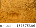 Ancient Carving on Weathered Stone Wall 131375306