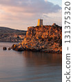 Coastal Watchtower on Rocky Cliff at Sunset, Malta 131375320