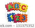 Colorful Foam Puzzle Pieces with Letters and Numbers 131375352