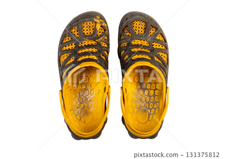 paint stained and heavily worn yellow black sandals. top view 131375812