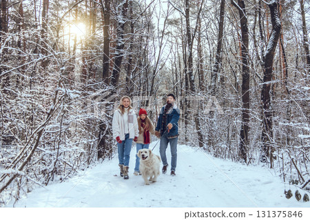 Cute young family and their dog spending day in winter forest Cute young family and their dog spending day in winter forest 131375846