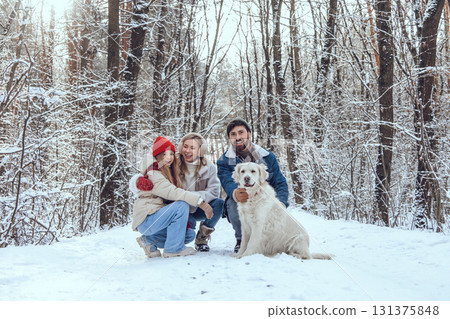 Cute young family and their dog spending day in winter forest Cute young family and their dog spending day in winter forest 131375848