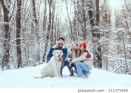 Cute young family and their dog spending day in winter forest Cute young family and their dog spending day in winter forest 131375849