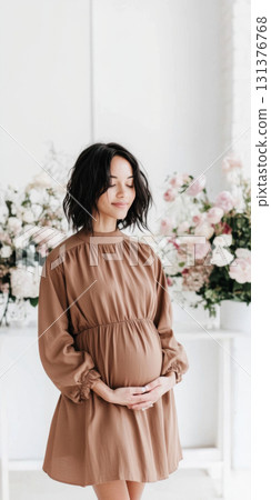 Pregnant woman with afro hairstyle smiling softly indoors, copy space Pregnant woman with afro hairstyle smiling softly indoors, copy space 131376768