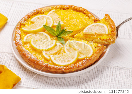 Delicious lemon tart with golden crust and smooth, glossy lemon filling 131377245