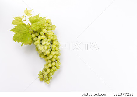 Fresh grapes lying on a white background, simple and clean food concept Fresh grapes lying on a white background, simple and clean food concept 131377255