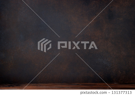 Rustic charm: Wooden table against a textured stone wall 131377313