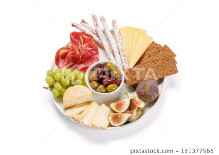 Antipasto platter with prosciutto, cheese, olives, salami, figs, grapes, and crackers 131377565