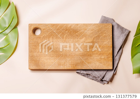 Empty cutting board on beige background with leaves, seasonal food mockup Empty cutting board on beige background with leaves, seasonal food mockup 131377579