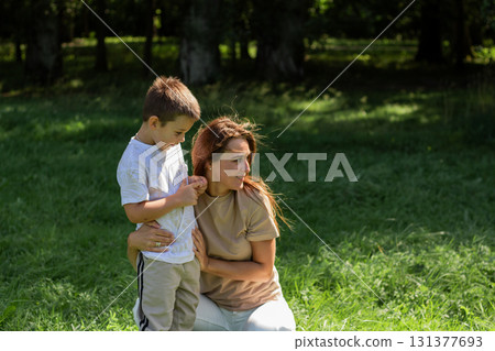 Cute preschooler boy hug cuddle with smiling young mother. Intimate moment between mom and son. Kissing show love. Embrace happy millennial mom 131377693