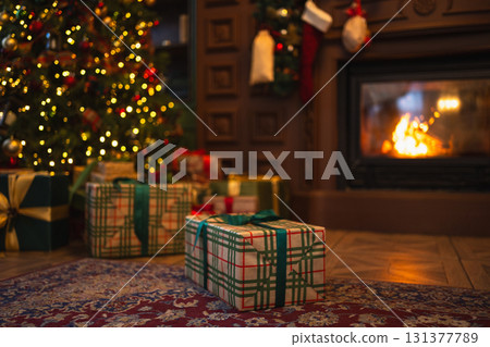 Green gift box in classical Christmas decorated interior living room library with fireplace. Christmas gift near fir tree on Christmas eve. Modern classic style interior design apartment. Christmas Green gift box in classical Christmas decorated interior living room library with fireplace. Christmas gift near fir tree on Christmas eve. Modern classic style interior design apartment. Christmas 131377789