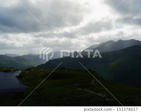 Picturesque mountain scenery featuring a small lake, ideal for travel blogs and tourism. 131378017