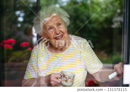 Portrait of senior woman with cup of tea. 131378115