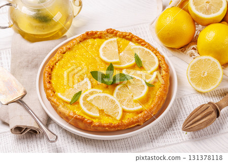 Delicious lemon tart with golden crust and smooth, glossy lemon filling 131378118