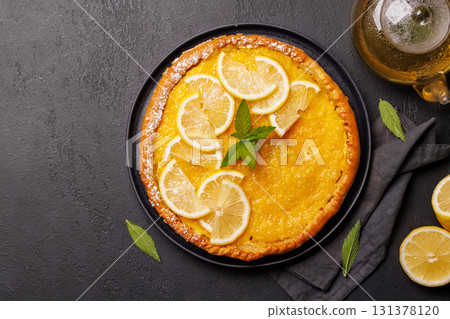 Delicious lemon tart with golden crust and smooth, glossy lemon filling Delicious lemon tart with golden crust and smooth, glossy lemon filling 131378120