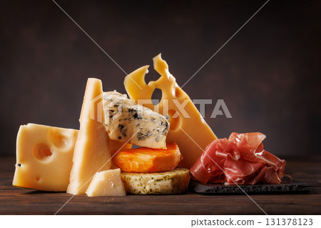Assorted cheeses in different shapes and textures displayed together Assorted cheeses in different shapes and textures displayed together 131378123