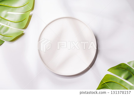 Empty plate on white background with leaves and shadows, food mockup with natural light Empty plate on white background with leaves and shadows, food mockup with natural light 131378157