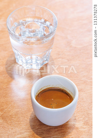 Freshly brewed espresso served in a small cup on a table Freshly brewed espresso served in a small cup on a table 131378278