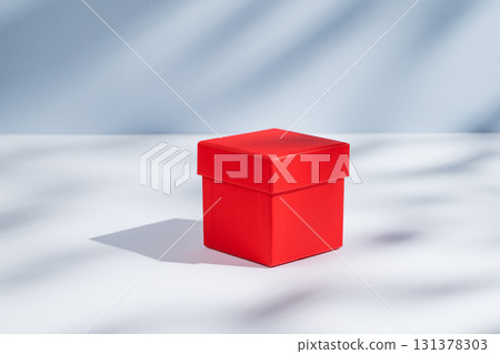 Red box on a white and blue background with soft shadows. Concept of a gift for a holiday 131378303