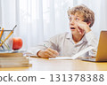 Schoolboy studying at home, doing homework 131378388