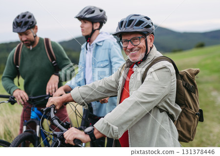 Grandfather, father and teen boy on cycling trip taking selfie. Grandfather, father and teen boy on cycling trip taking selfie. 131378446