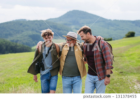 Grandfather, father and teen boy hiking togeter in nature, spending time together during weekend. Grandfather, father and teen boy hiking togeter in nature, spending time together during weekend. 131378455