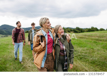 Mature daughter and her mom on family hiking trip in nature. Mature daughter and her mom on family hiking trip in nature. 131378457