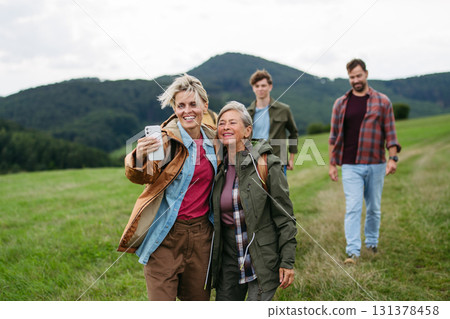 Mature daughter and her mom taking selfie. 131378458