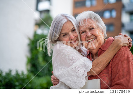 Portrait of beautiful adult daughter with old mother. Portrait of beautiful adult daughter with old mother. 131378459