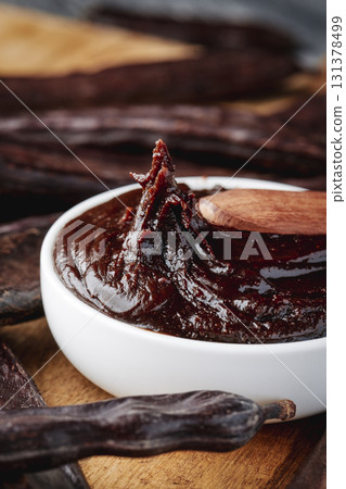 a spoon lifts carob cream from a white bowl 131378499