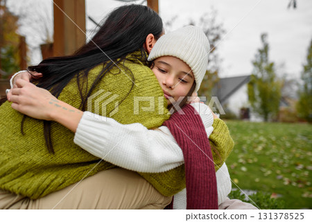 Portrait of beautiful mother with young daughter in the middle of autumn garden. 131378525