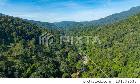 Aerial view of A small winding road winds through the valley. 131378533