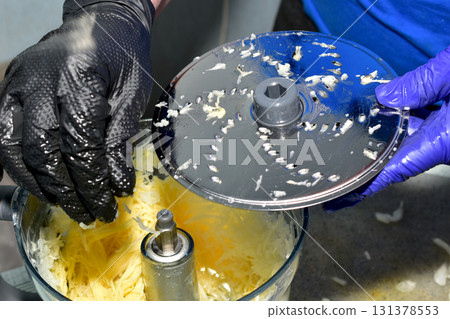 Removing the blade from an electric vegetable grater. Removing the blade from an electric vegetable grater. 131378553