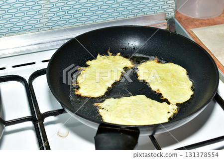 Pancakes are being fried in a frying pan Pancakes are being fried in a frying pan 131378554