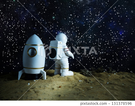 Miniature astronaut figurine with space shuttle on alien planet, gazing at starry cosmos, concept of scientific discovery and spirit of space exploration. Miniature astronaut figurine with space shuttle on alien planet, gazing at starry cosmos, concept of scientific discovery and spirit of space exploration. 131378596