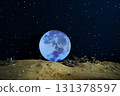 Majestic giant Moon rising above alien planet surface under sparkling starry sky, symbol of cosmic and interplanetary exploration. Night scene of glowing Moon seen from distant planet surface. 131378597