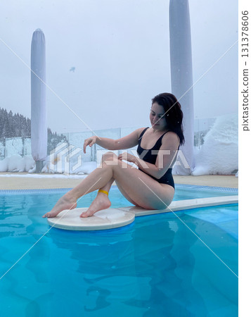 Winter Poolside Relaxation in Snowy Landscape Winter Poolside Relaxation in Snowy Landscape 131378606
