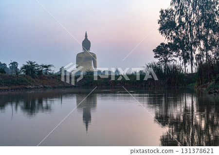reflection of the biggest Buddha in the swamp at sunrise. reflection of the biggest Buddha in the swamp at sunrise. 131378621
