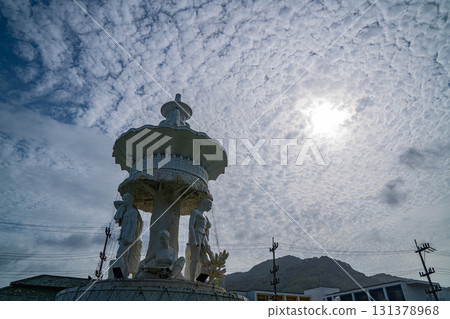 Karon Beach Roundabout Sculpture in the Hazy Glow of a Puffy Cloud-Filled Sky Karon Beach Roundabout Sculpture in the Hazy Glow of a Puffy Cloud-Filled Sky 131378968