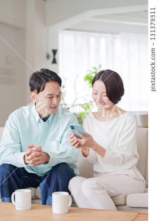 Couples looking at smartphones Couples looking at smartphones 131379311